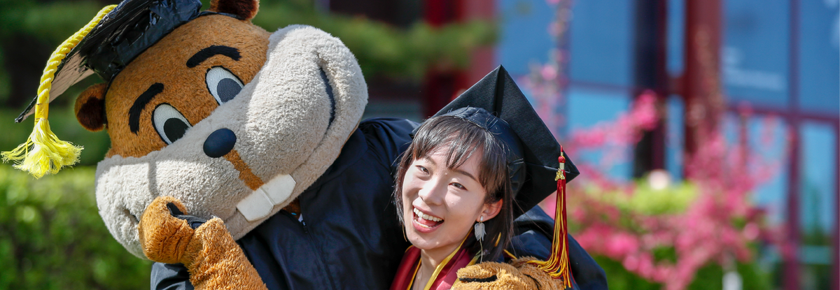goldy the gopher wearing a graduation cap and gown